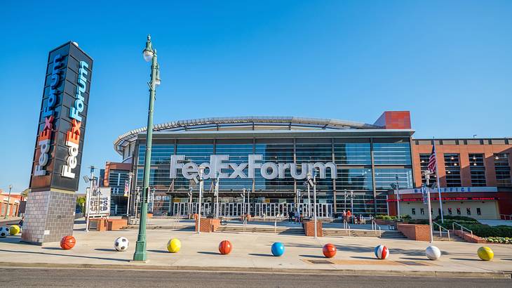 A sports venue with signs that say "FedExForum" with colored balls in front