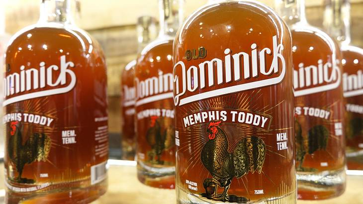 Bottles of alcohol with a rooster image and an "Old Dominick Memphis Toddy" label Bottles of alcohol with a rooster image and an "Old Dominick Memphis Toddy" label