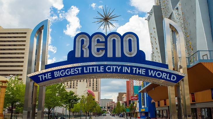 A blue arch over a city street that says "Reno, The Biggest Little City in the World"