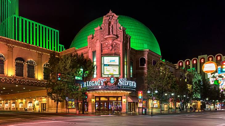 A building with a green dome illuminated at night