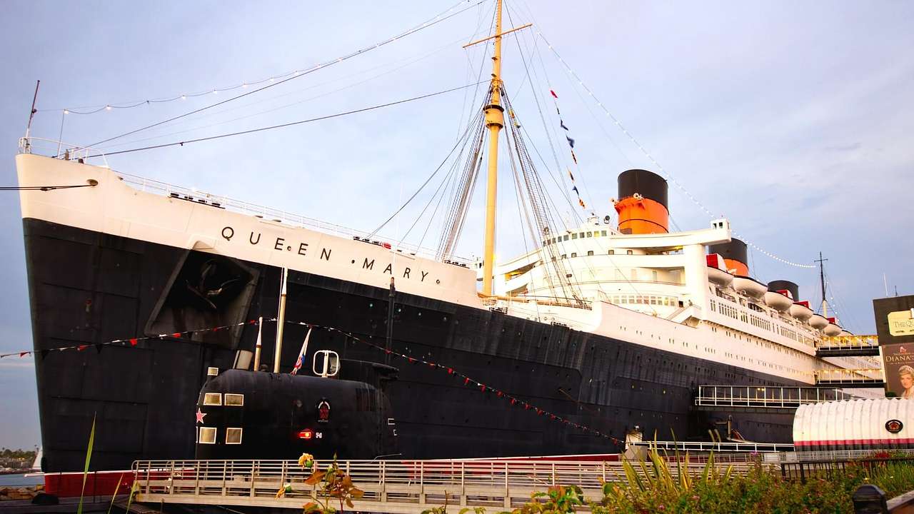 A black and white ocean liner that says "Queen Mary" on it