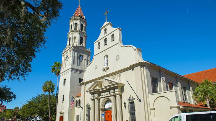A white church building with Spanish Colonial Revival architecture under a clear sky