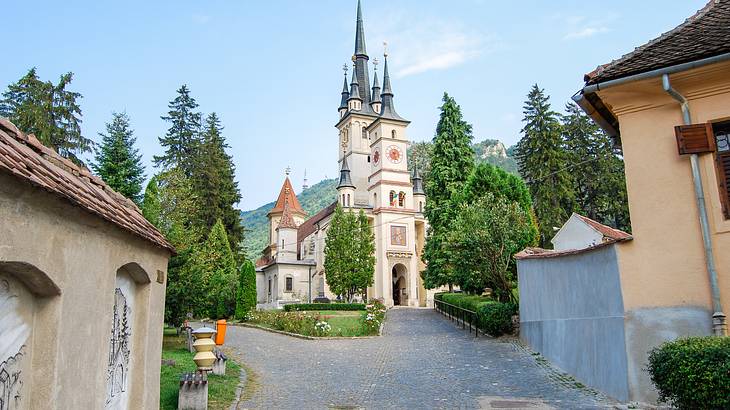 Picture of a beautiful church up a hill in between other buildings, Brasov, Romania