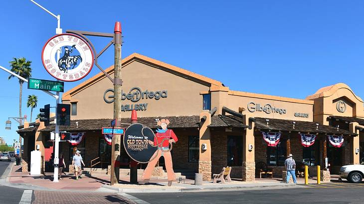 A store next to a cowboy figure and a sign that says "Old Town Scottsdale"
