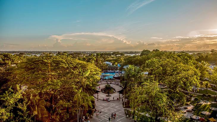 A public square surrounded by trees under a blue sky