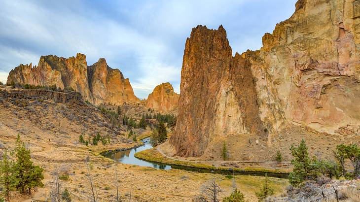 A river winding along the base of rocky ridge mountains