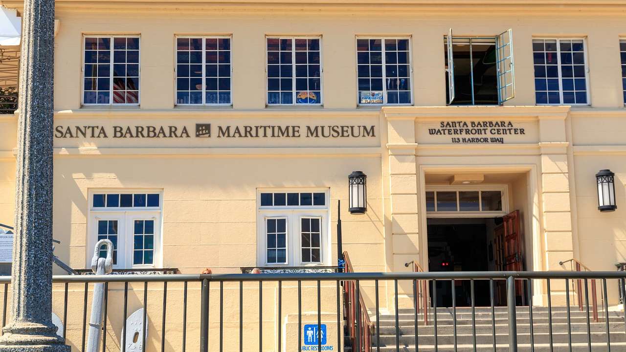 A pale yellow two-story building with a "Santa Barbara Maritime Museum" sign