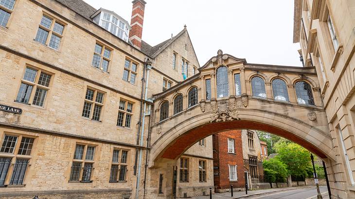 A covered arch bridge connecting two buildings across the street from each other