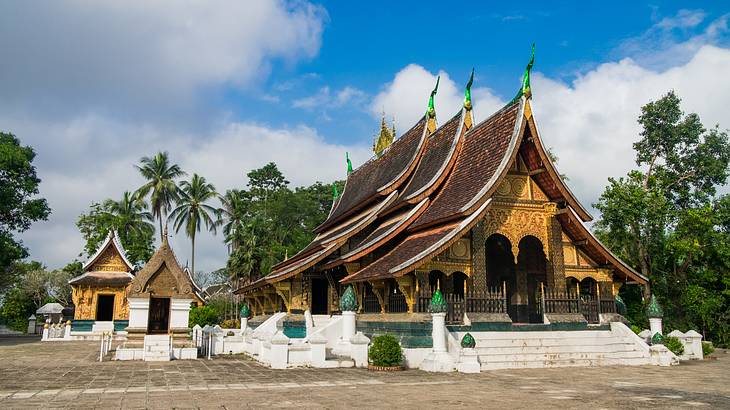 One main temple with two smaller ones in the courtyard and trees in the back