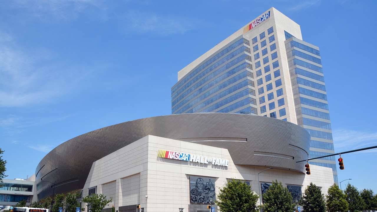 A building with a "NASCAR Hall of Fame" sign connected to another tall building
