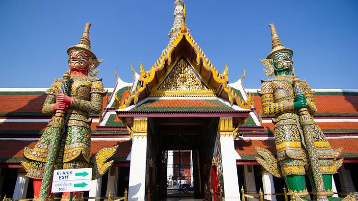 A temple with two large statues on both sides of the entrance