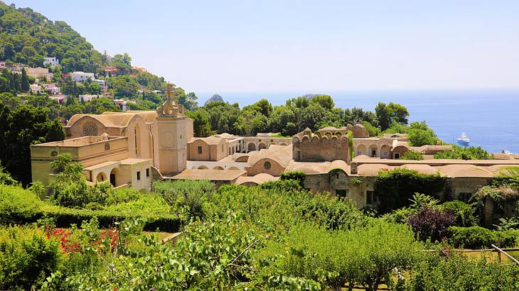 An old cloister surrounded by trees overlooking the sea