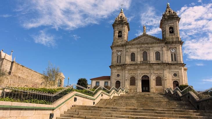 Wide concrete stairs leading to a church with two bell towers