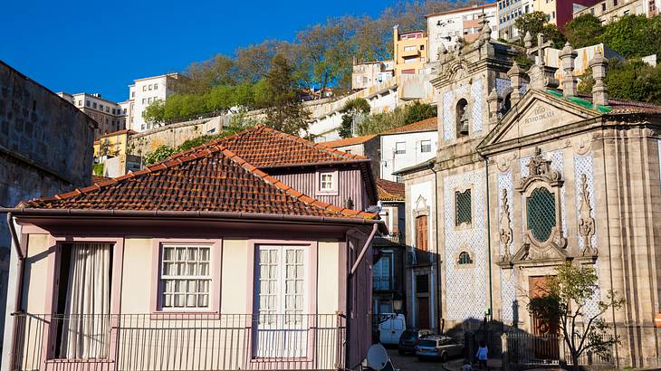 An old church surrounded by houses on a hilly terrain