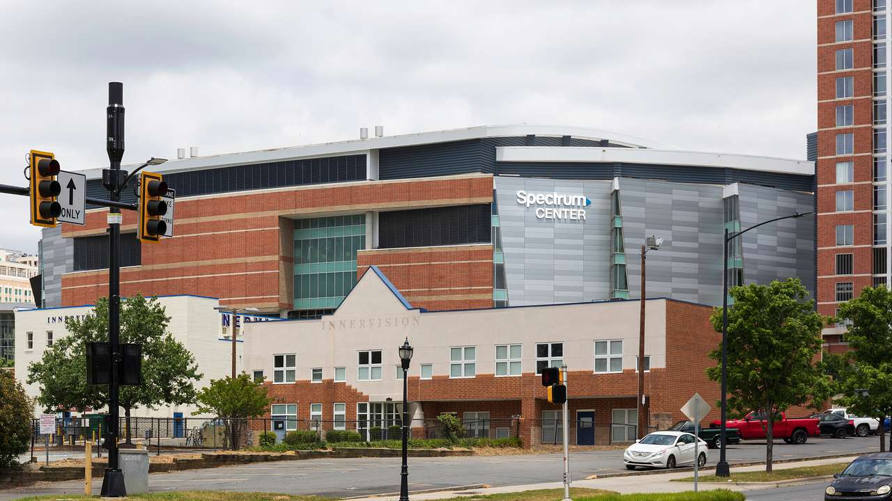 A parking lot and a large brick building with a "Spectrum Center" sign