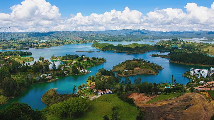 An aerial view of water surrounded by greenery-covered land and islands