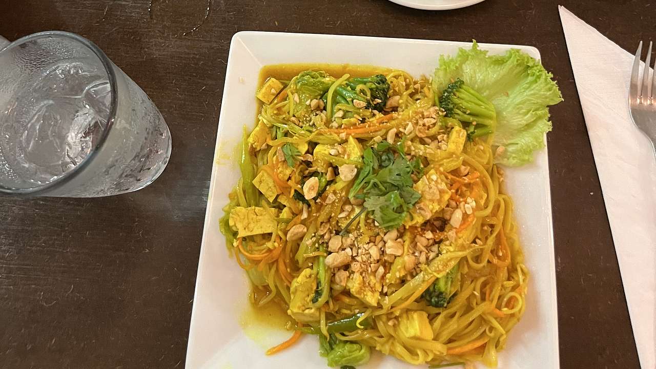Looking down at a plate of Pad Thai noodles with vegetables