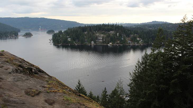 View of Deep Cove from the top of a rock overlooking hills and water