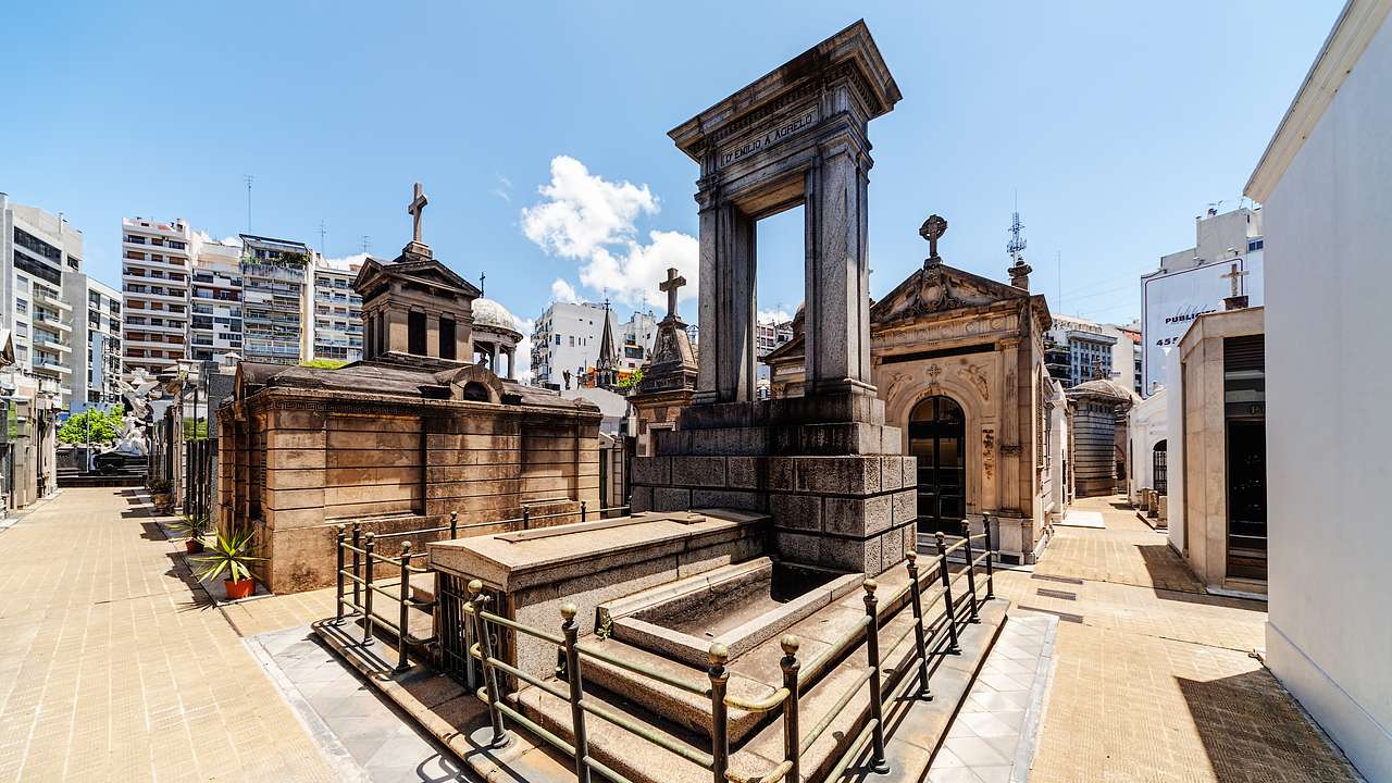 Old mausoleums and tombs with crosses, and different designs under the blue sky
