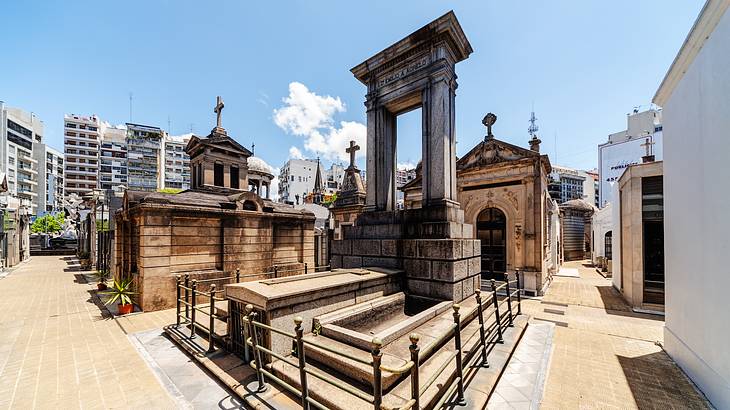 Old mausoleums and tombs with crosses, and different designs under the blue sky