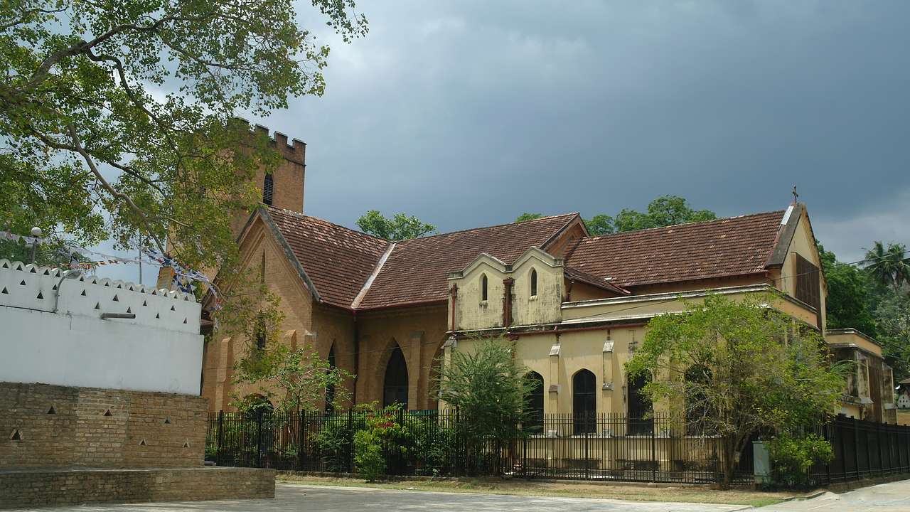 A church with a terracotta bricked top on a cloudy day