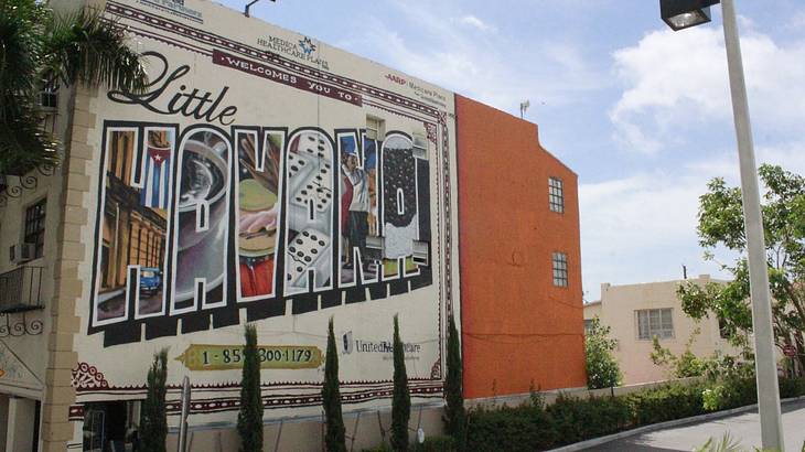 A building on a street with a "Little Havana" mural on it