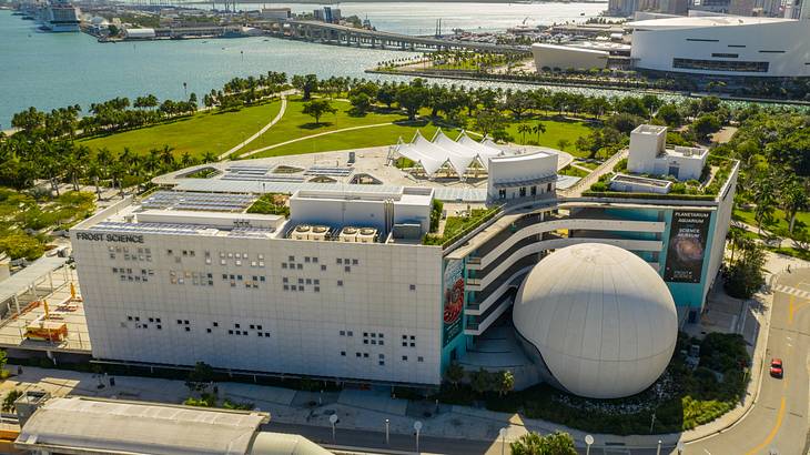 Aerial view of a modern building with a huge white spherical dome