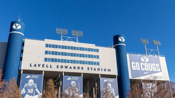 The entrance to a football stadium with blue banners and columns