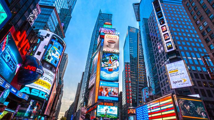 Illuminated billboards on tall buildings under the night sky