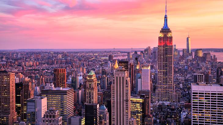 The NYC skyline with Empire State Building under a pink sky