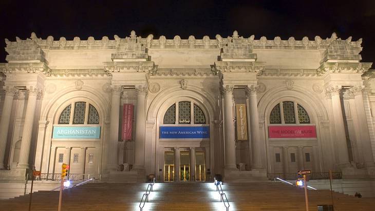 A grand art museum facade with columns at the top of stairs at night