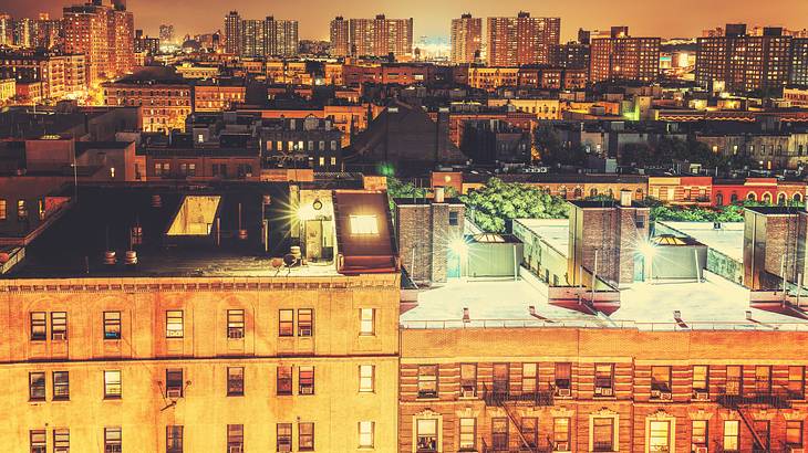 Buildings with a city skyline in the background under an orange light