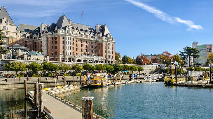 A castle-styled building next to the water with a boat parked on it