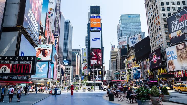 An urban area with many billboards and advertisements on buildings