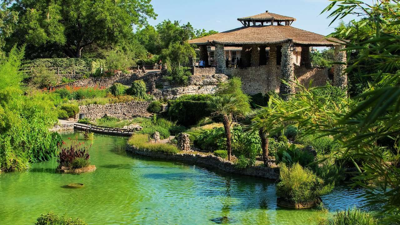 A landscaped garden with a pond and a gazebo