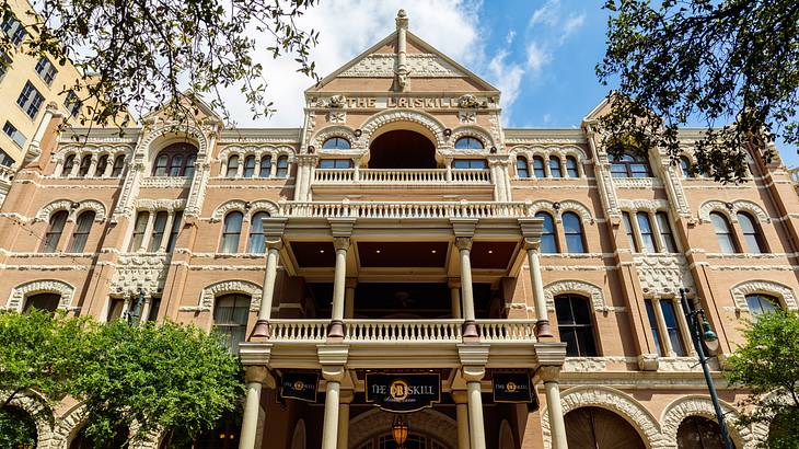 A building facade with columns and balconies under a blue sky