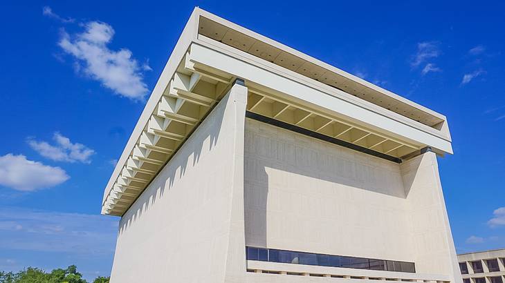 A cream square-shaped building under a blue sky