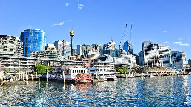 Buildings near a body of water with ships docked by the harbor