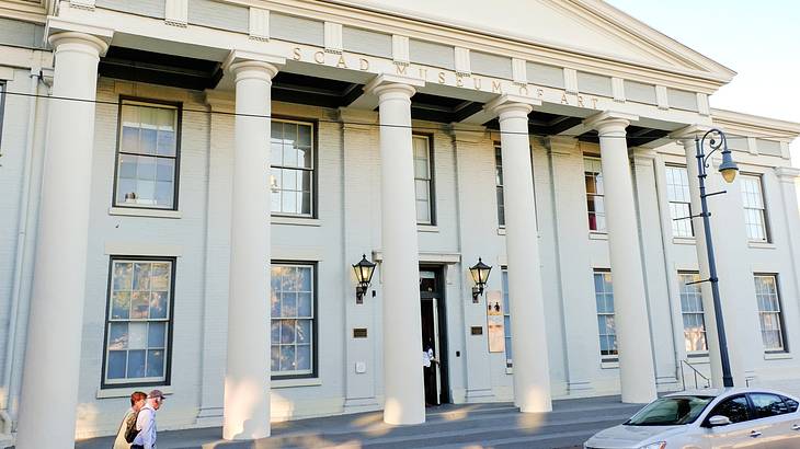 A white building with large pillars and "SCAD Museum of Art" engraved on it