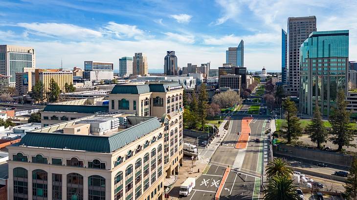 A city skyline of tall buildings with a street running through the middle