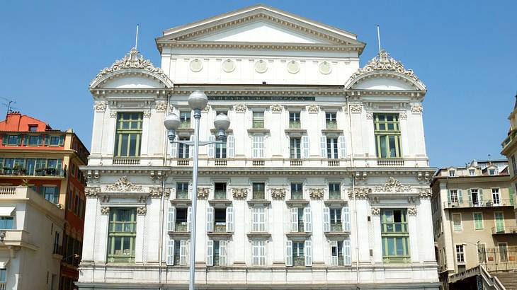 The outside of a white opera building in Nice, France
