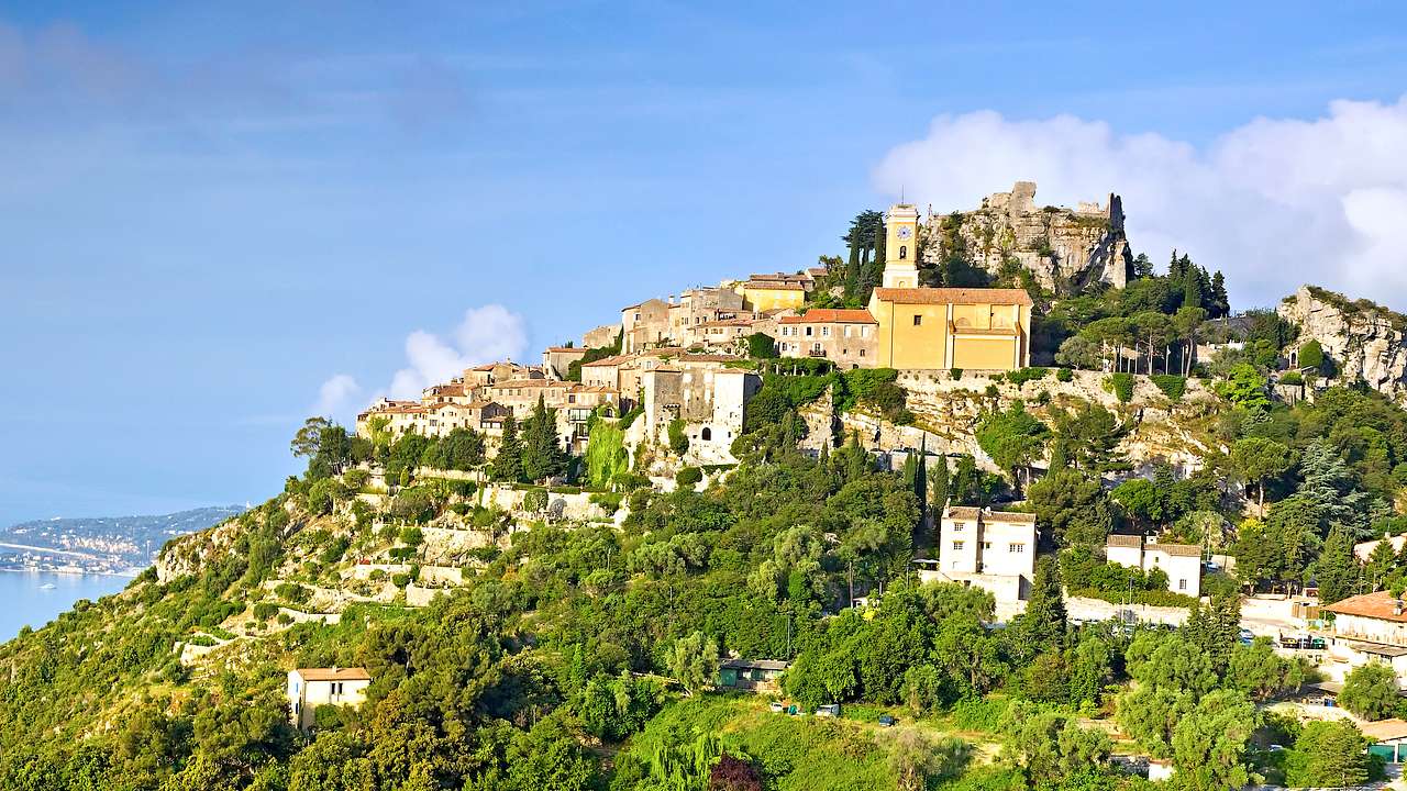 A view of the French village, Eze, on a hill full of green nature and houses