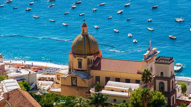 Low-angle shot of a cathedral with a small dome top with the sea in the background