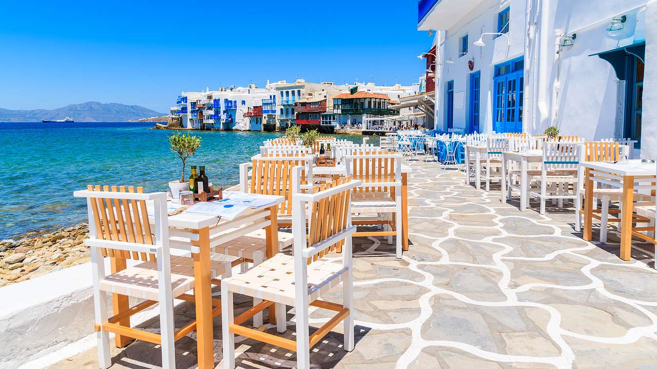 Wooden tables and chairs of a restaurant by the beach