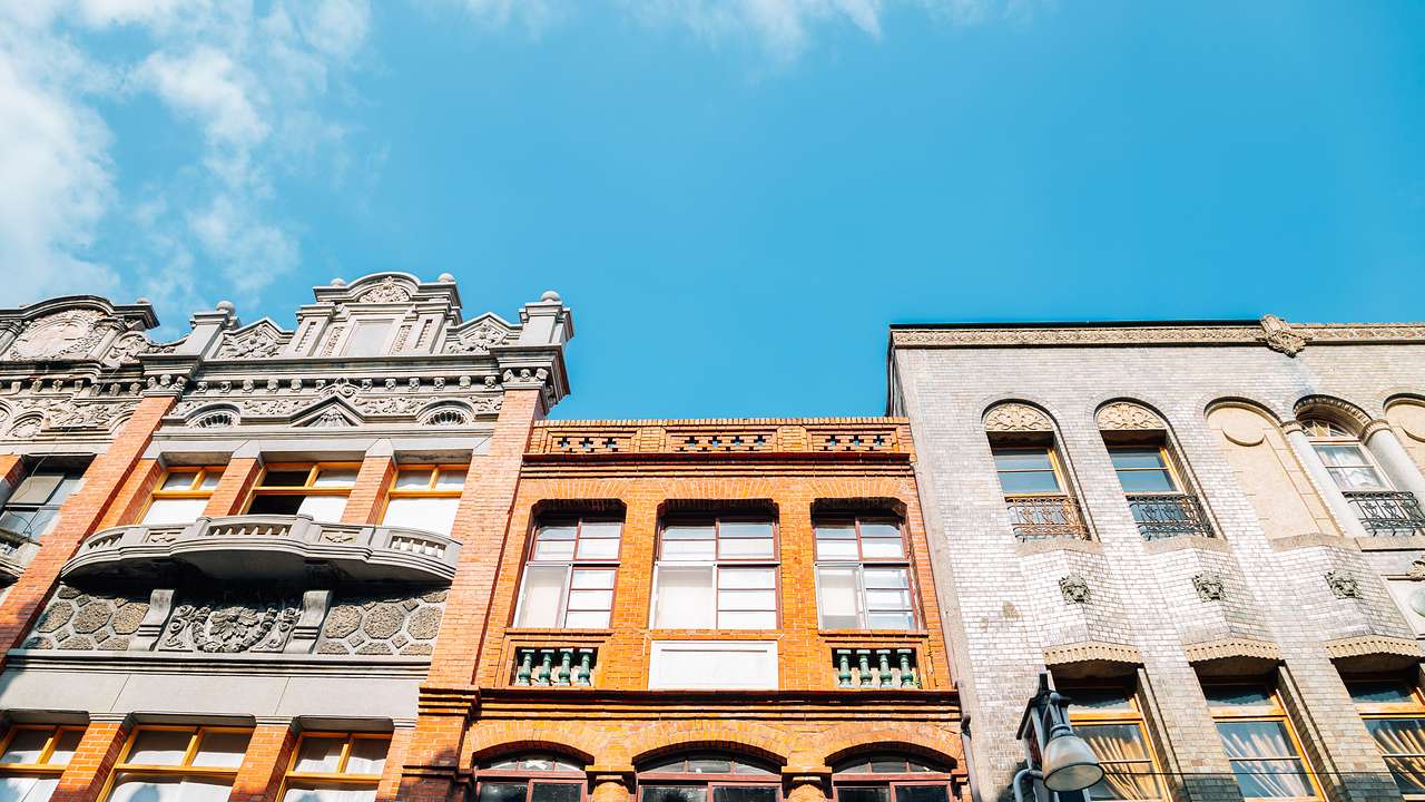 Adjacent old colorful buildings under a blue sky