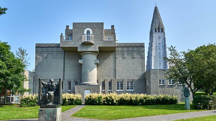 A church building next to grass and a path under a blue sky