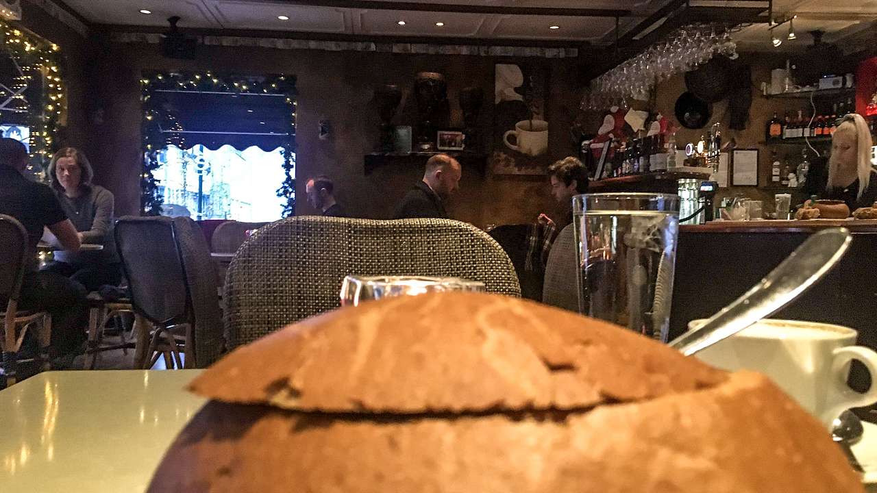 A soup bread bowl on a table in a cafe
