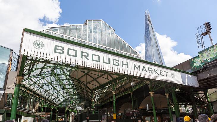 A market featuring a large entrance sign that says "Borough Market" and a glass roof