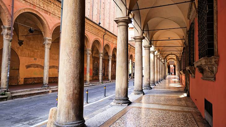 Empty marbled sidewalks with archways and columns