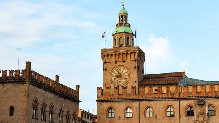 A brick building with a clock tower under a blue sky